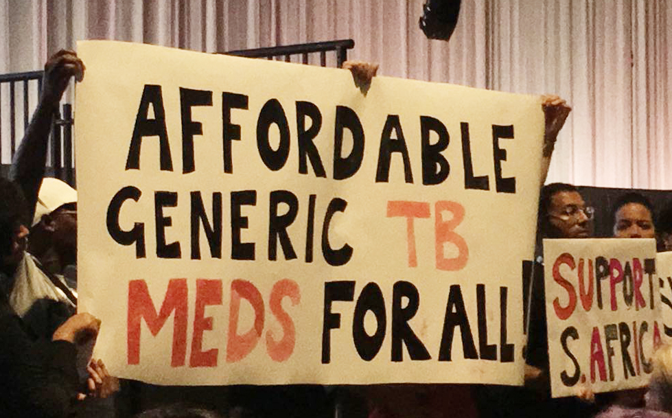 People holding banners that read "Affordable Generic TB Meds for All" and "support south africa"