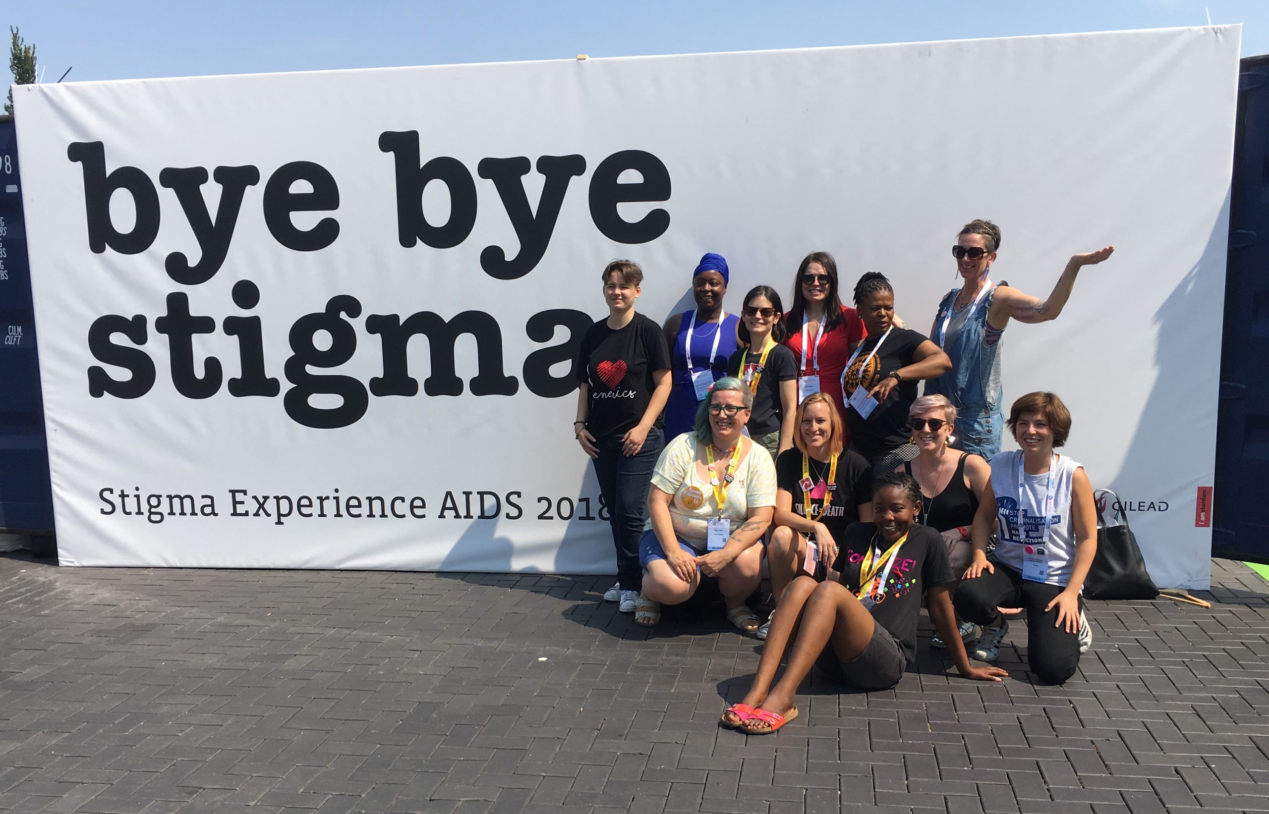Banner that reads bye bye stigman with a group of people in front of it