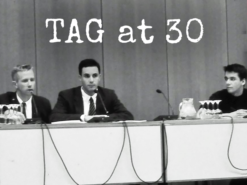 graphic that reads "TAG at 30" the photo is of three young white men behind a table. It's Mark Harrington, Gregg Gonsalves, and Spencer Cox in Amsterdam in 1992