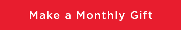 white text on a red background that reads make a monthly gift