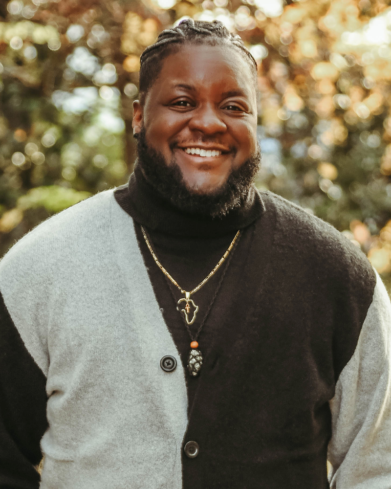 photo of Moe Ari Brown, black man with beard with a very nice smile, and he's dressed casually