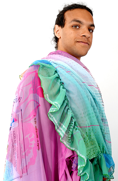 young man modeling the shawl that's part of the 2023 Limited Art Edition by Ivy Kwan Arce