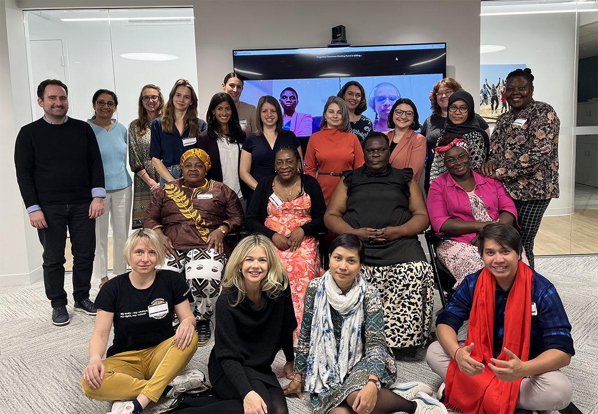 Group of people of various ages and races in what's obviously a meeting room. Most of them are smiling.